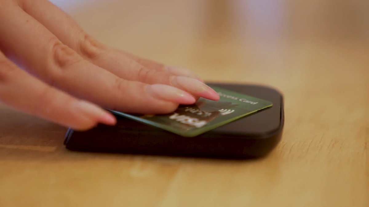 Customer using their debit card to make a purchase at Stackt in Toronto.
