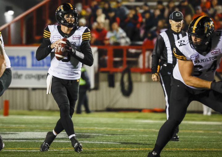 Hamilton Tiger-Cats quarterback Dane Evans looks for a receiver during first half CFL football action against the Calgary Stampeders in Calgary, Friday, Oct. 14, 2022.