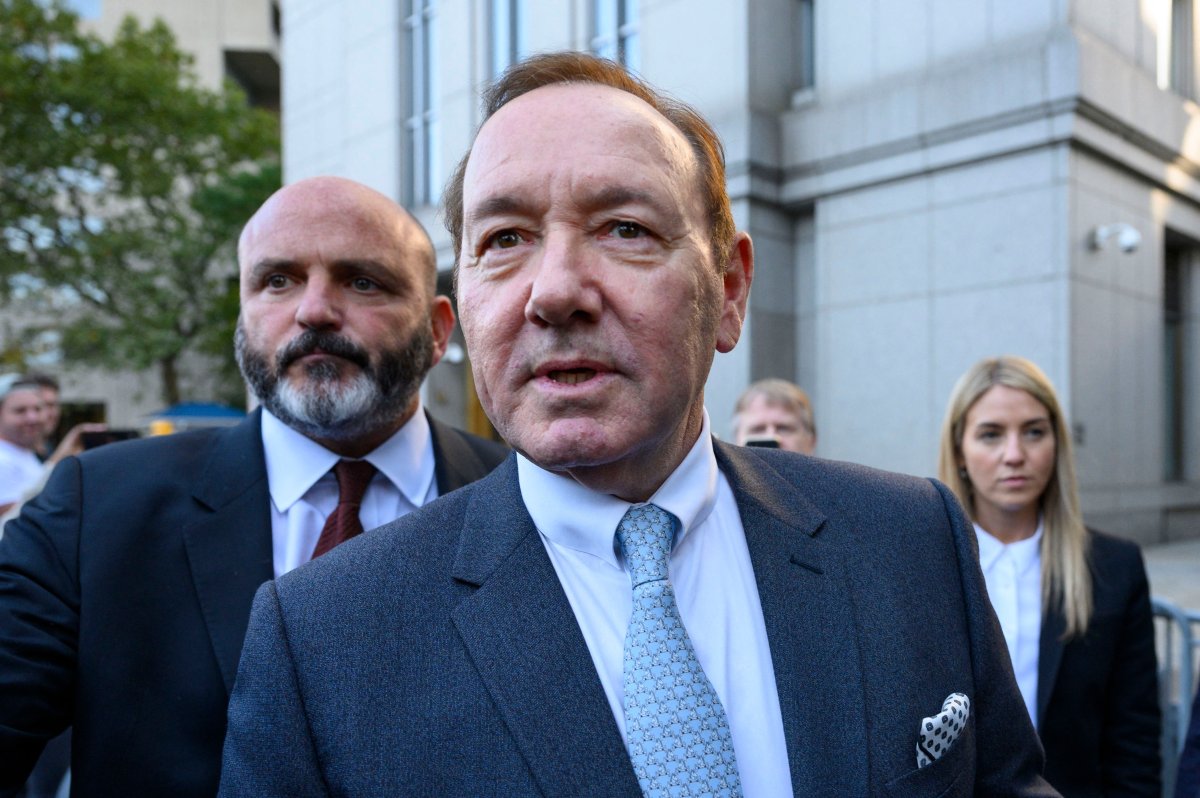 Kevin Spacey in a suit and light blue tie.