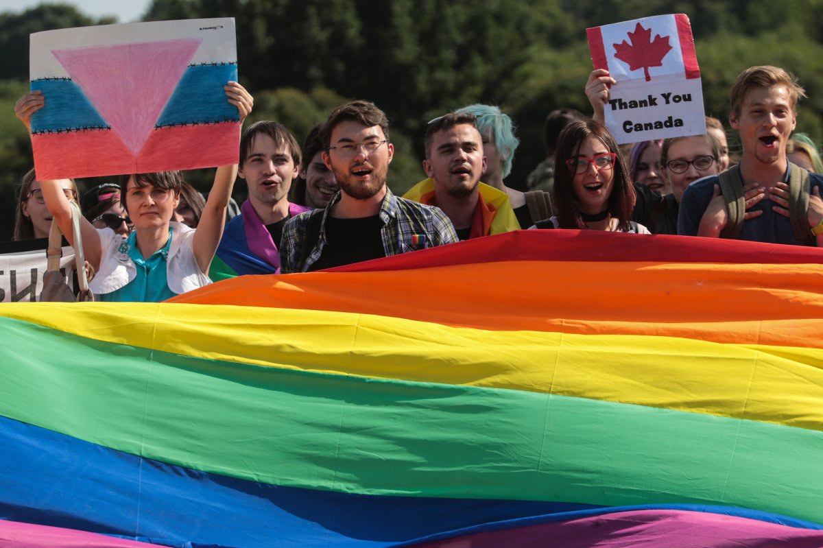 Participants hold a rainbow flag commonly known as the LGBTQ2 pride flag during a Gay Pride demonstration.