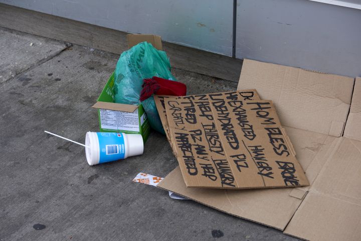 File photo of items belonging to a person experiencing homelessness, including a cardboard sign.