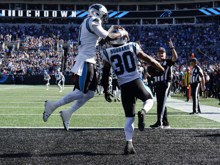 Carolina Panthers running back Chuba Hubbard (30) celebrates with teammate quarterback PJ Walker, left, after a touchdown during the second half of an NFL football game against the Tampa Bay Buccaneers Sunday, Oct. 23, 2022, in Charlotte, N.C.