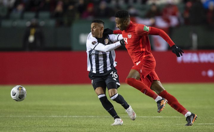 Team Canada's Mark-Anthony Kaye (14) and Costa Rica's Youstin Delfin Salas Gomez (16) vie for the ball during second half World Cup qualifier soccer action in Edmonton on Friday, November 12, 2021. 