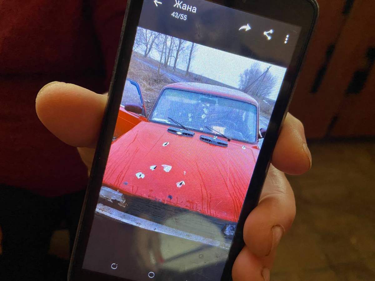 Maria Kivshar shows photo of her car after it was shot up by Russian troops, killing her granddaughter.