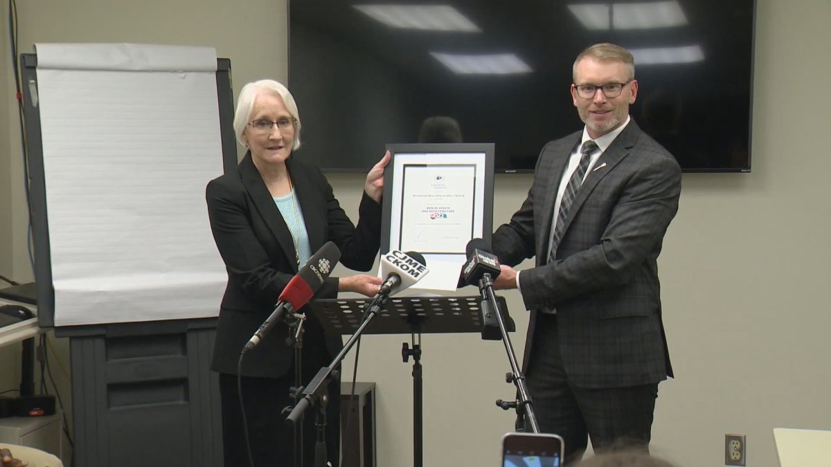 Everett Hindley presents award to the Saskatchewan Canadian Mental Health Association for monitored game that combat cyberbullying and its impact on mental health.