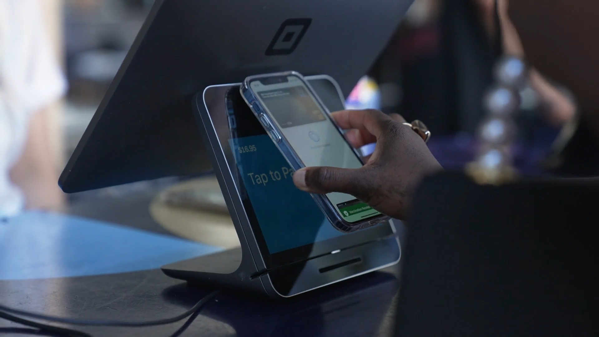 Someone using their mobile wallet to make a purchase.