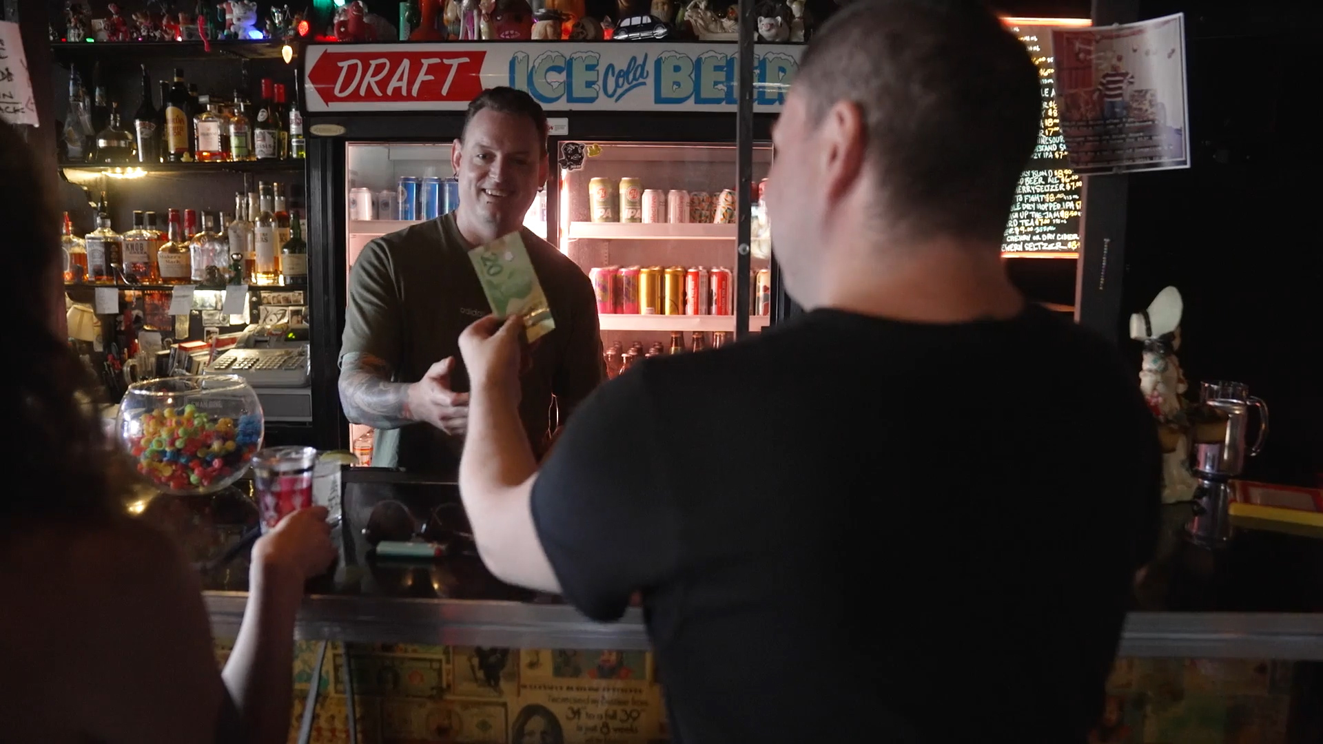 Customer using a $20 bill to pay for their drink at Swan Dive.