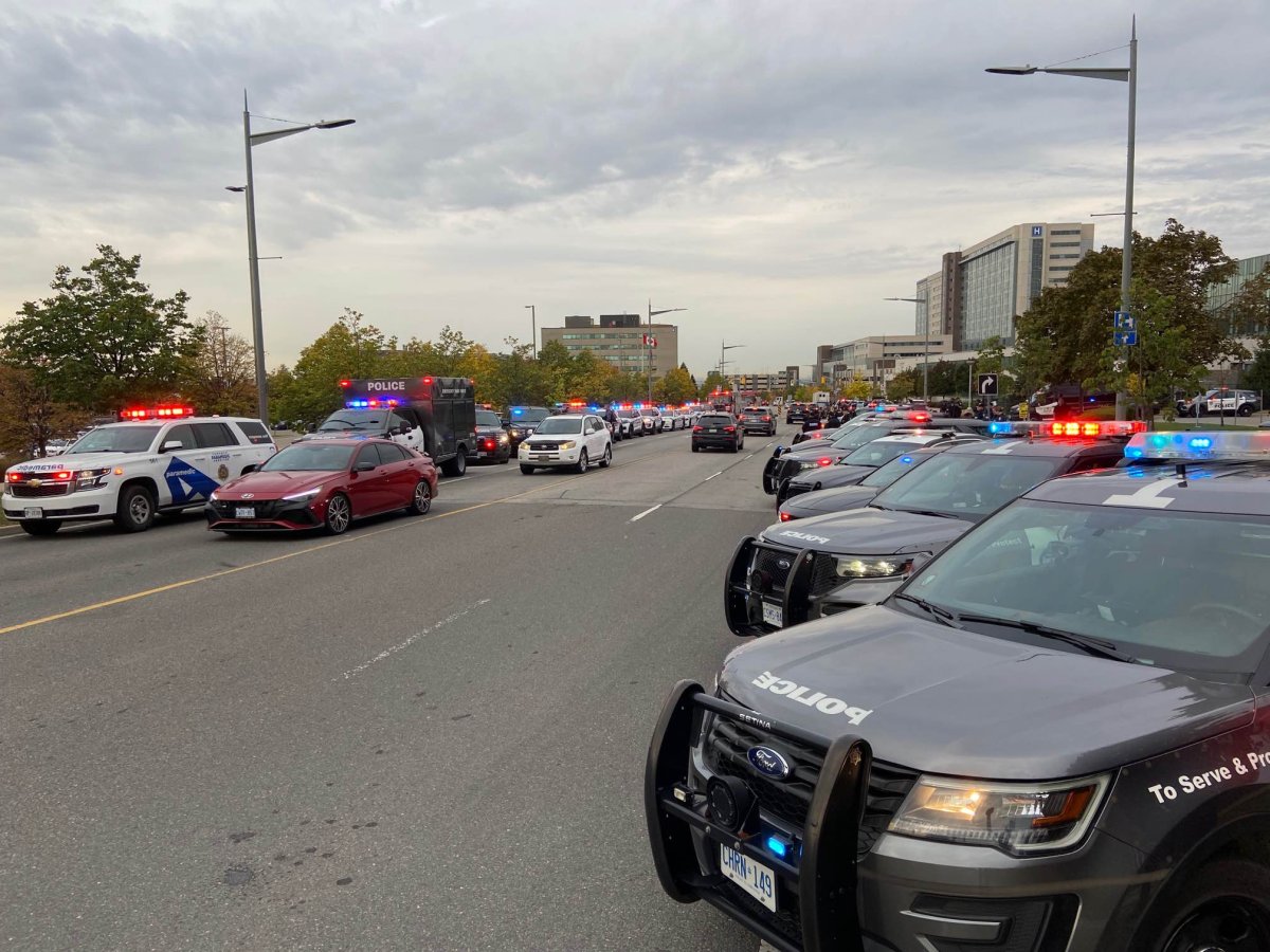 Police escorting the second fallen officer from a Toronto hospital to the Office of the Chief Coroner.