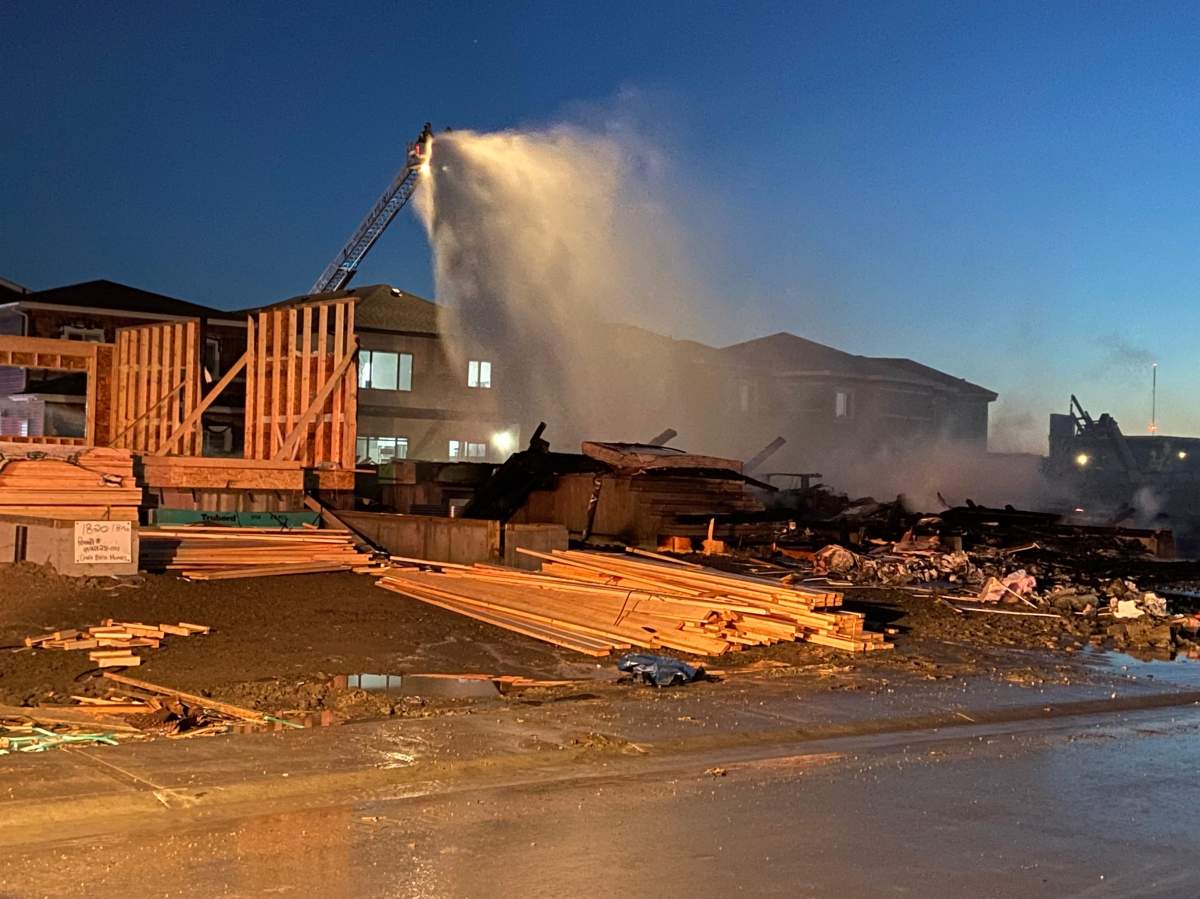 Edmonton Fire Rescue Services battle a fire at a house under construction in the city's southeast on Oct. 11, 2022.