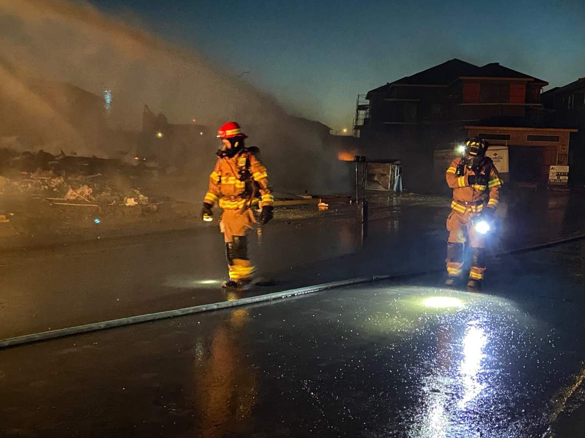 Edmonton Fire Rescue Services battle a fire at a house under construction in the city's southeast on Oct. 11, 2022.