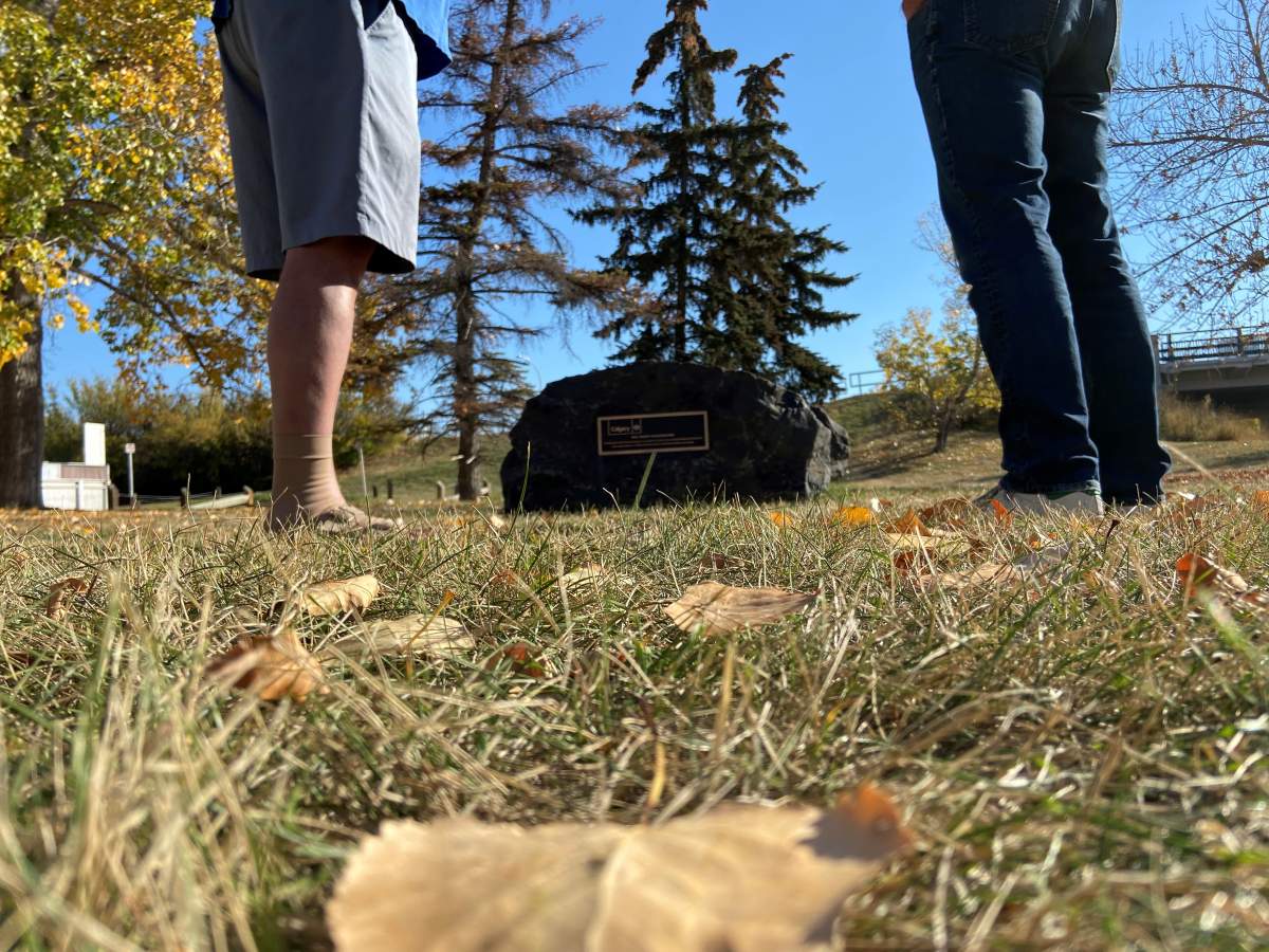 Bryce Paton and John Pentland stand beside Smokey’s rock.