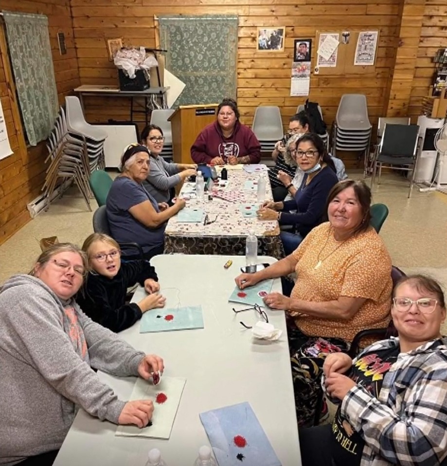 Helen Bernard-Ward is seen teaching others how to bead.