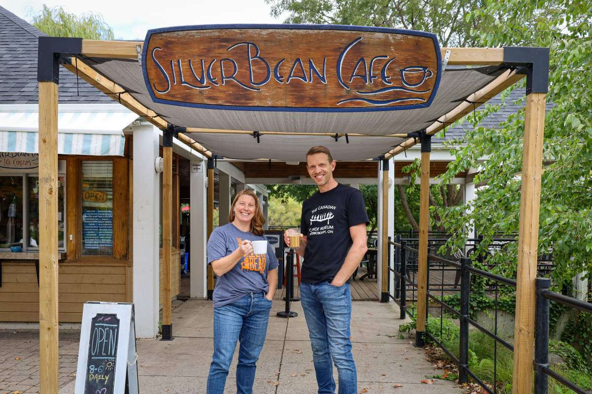 Carolyn Hyslop, executive director of the Canadian Canoe Museum and Dan Brandsma, owner of the Silver Bean Cafe, celebrated their new partnership by donning each other’s T-shirts and raising a cup of coffee to their future together.