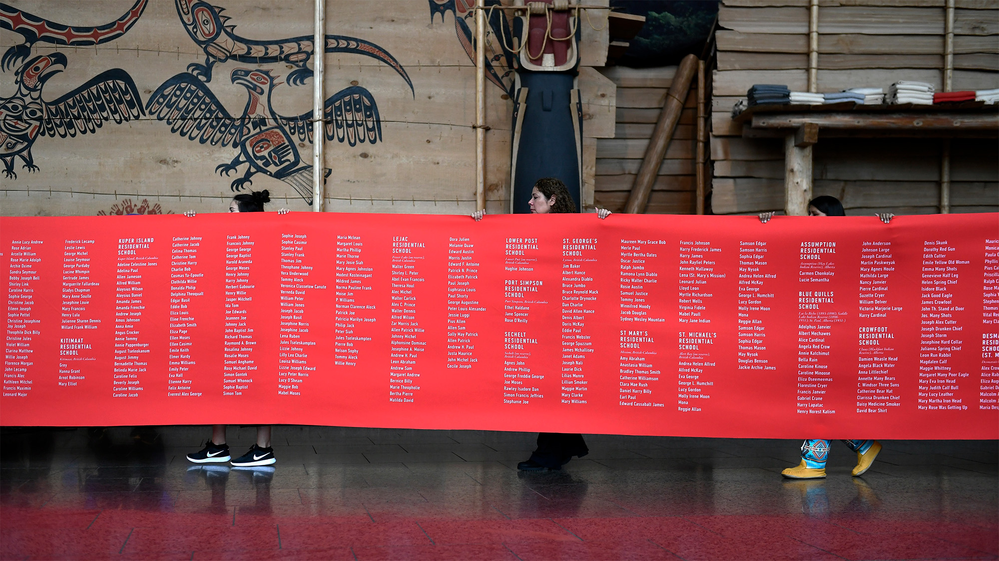 A ceremonial cloth with the names of 2,800 children who died in residential schools and were identified in the National Student Memorial Register, is carried to the stage during the Honouring National Day for Truth and Reconciliation ceremony in 2019.
