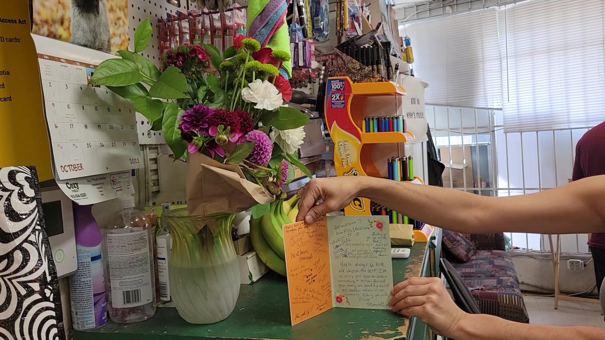 Customers left flowers and a “get well” card for Kamil at the store.