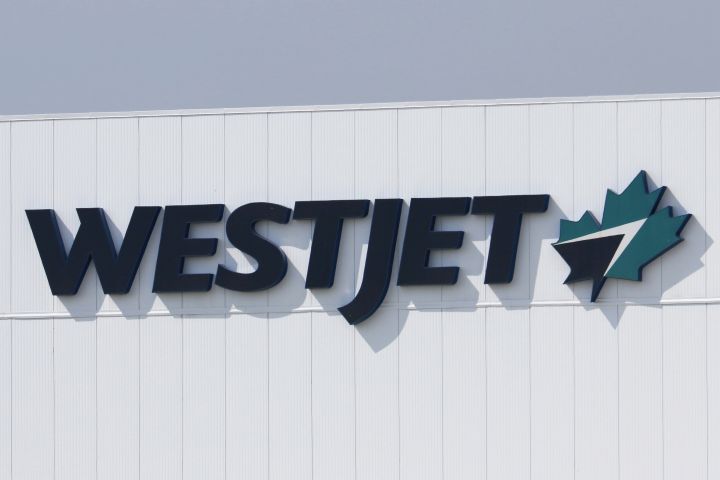 The corporate logo for WestJet Airlines is seen on a main hangar in Calgary, Alberta on Aug. 21, 2022. 
