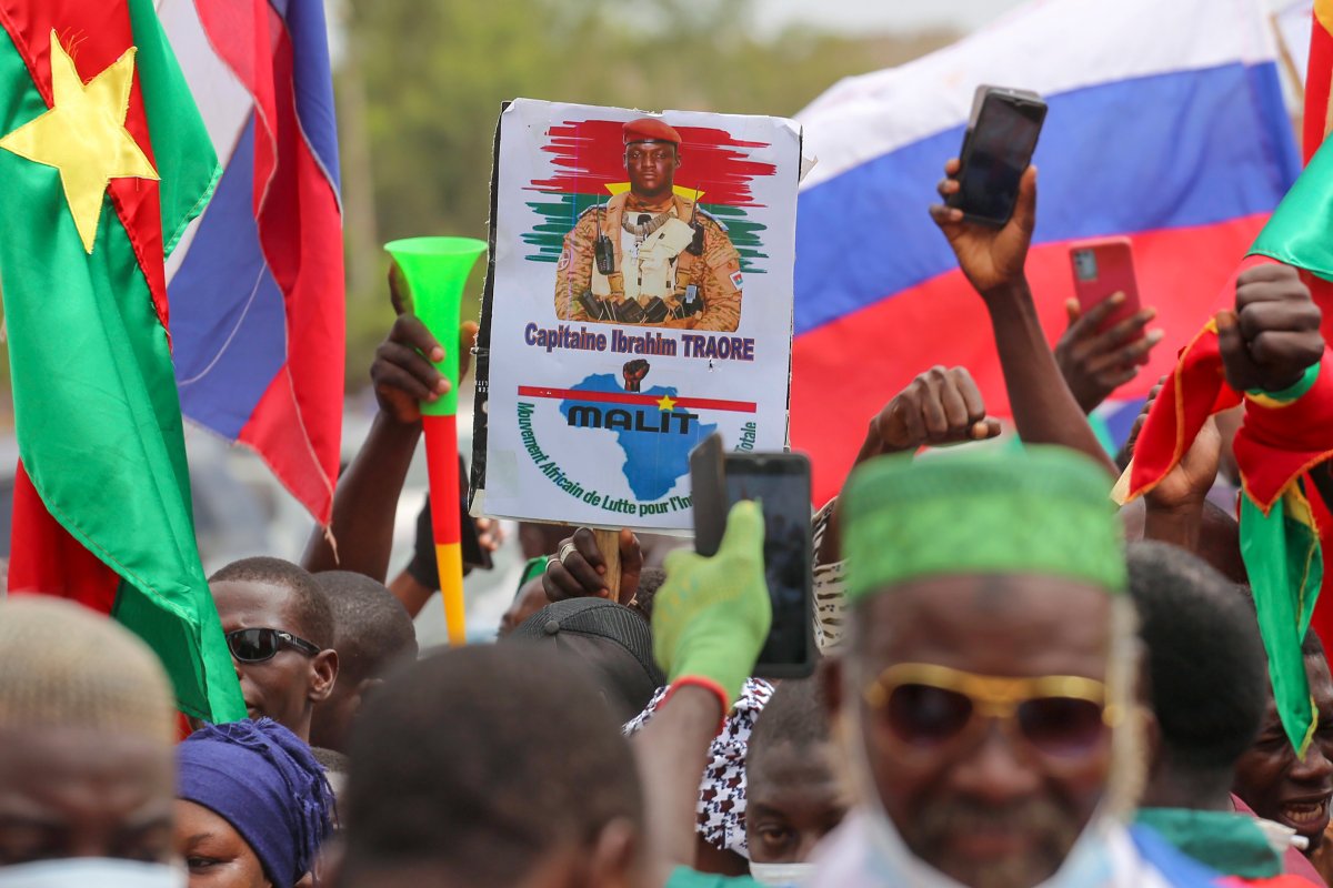Supporters of Burkina Faso's latest coup leader Capt. Ibrahim Traore gather outside the National Assembly waving Burkina and Russian flags as Traore was appointed Burkina Faso's transitional president in Ouagadougou, Burkina Faso, Friday Oct. 14, 2022.