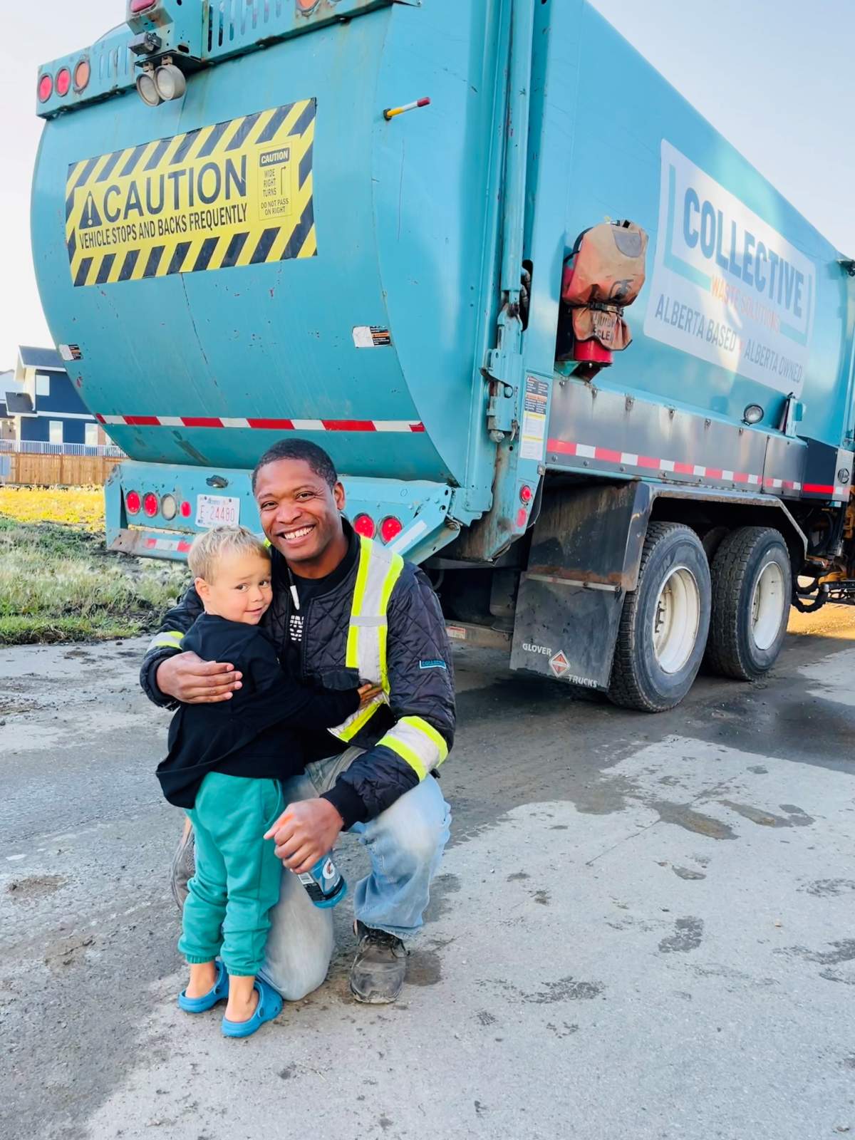 Clint and Nolan outside his garbage truck.