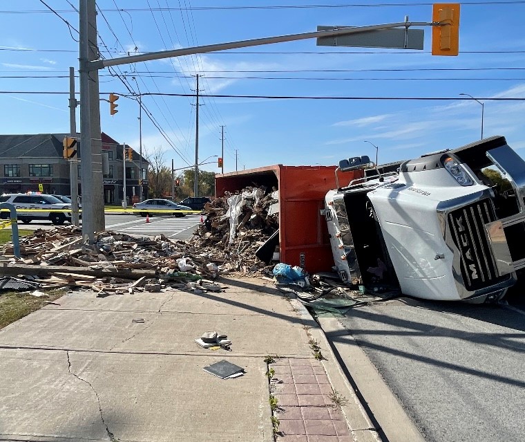 Police say one person is injured after a dump truck tipped over in Brampton.