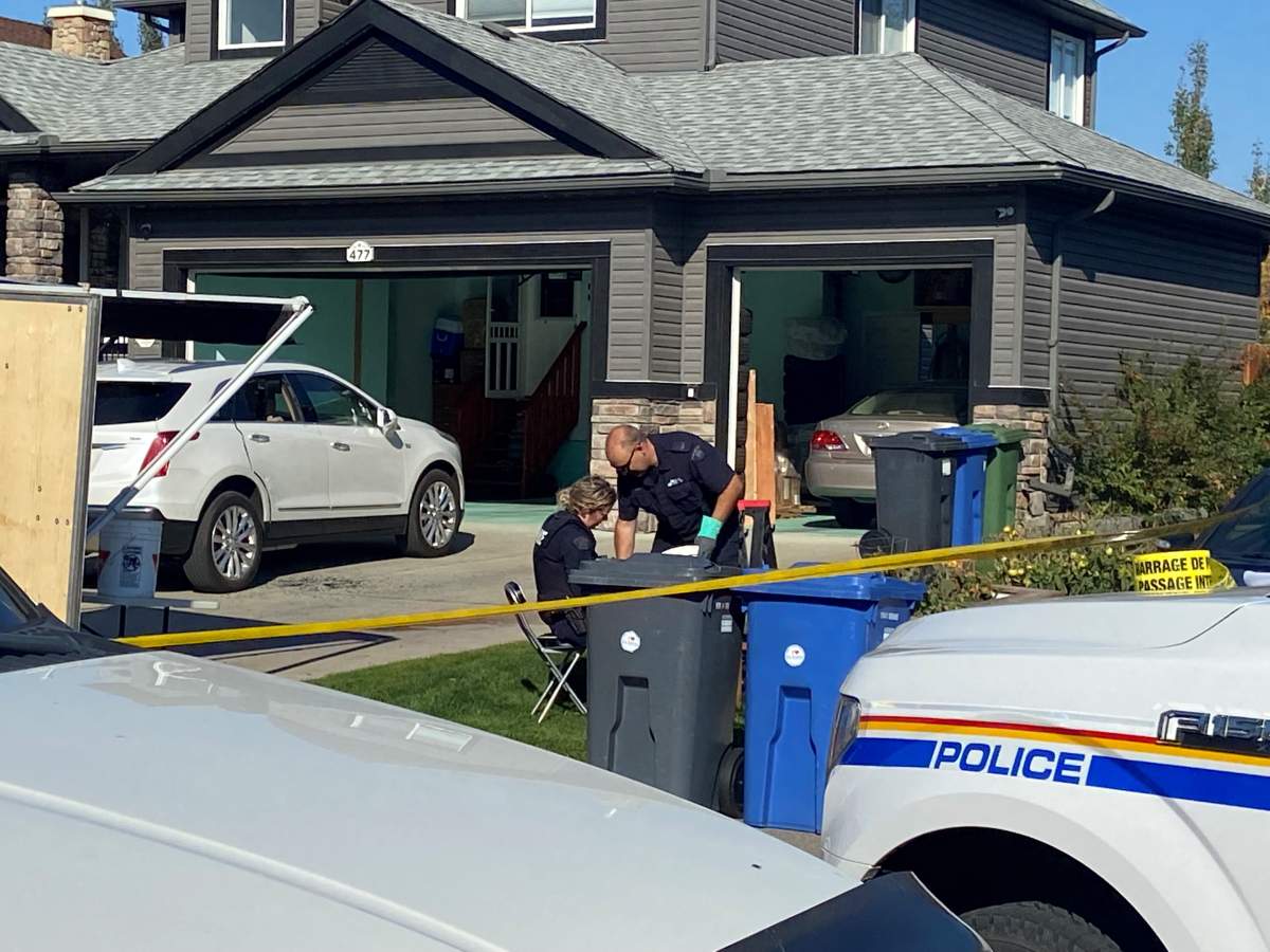 RCMP sift through glass and debris at the scene of the shooting. Oct. 8, 2022.
