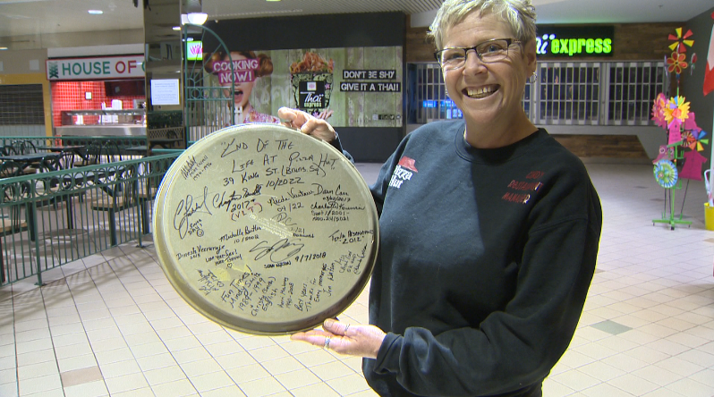 Manager Cindy Lockhart has worked at the location since 1987, and had a serving tray signed with past and present employees