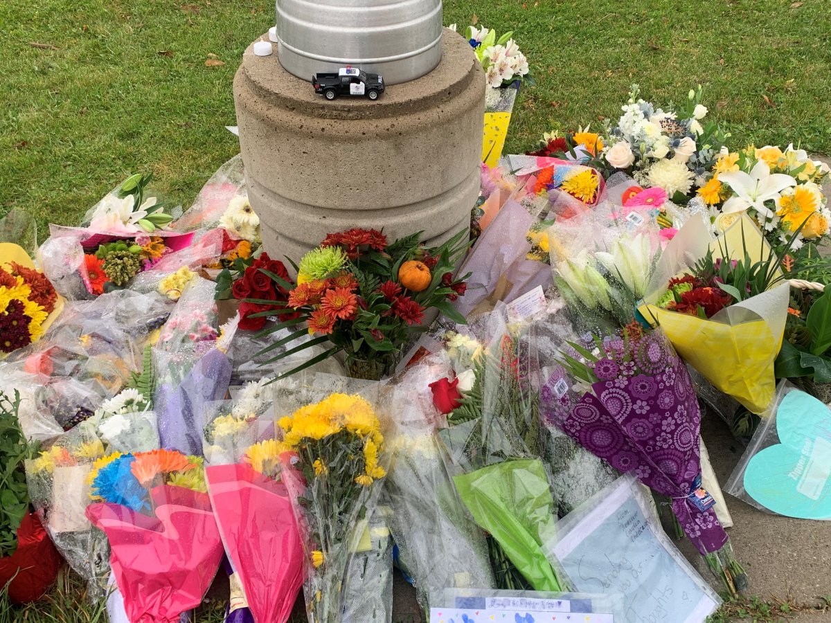 Flowers laid in memory of Constable Devon Northrup and Constable Morgan Russell, who were shot and killed in Innisfil, Ont.