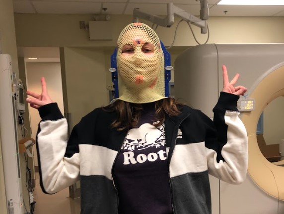 Rebecca Grundy poses for a photo during the fitting for her radiation mask in 2018