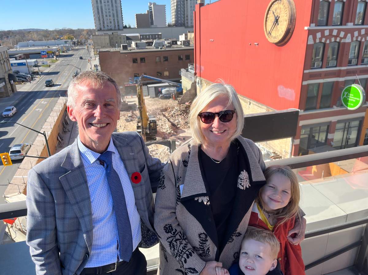 Y.O.U. CEO Steve Cordes, Lynne Cram, daughter of Joan Smith, and Cram’s grandchildren, Evan and Amy, on Nov. 7, 2022. Construction on Joan’s Place can be seen in the background.