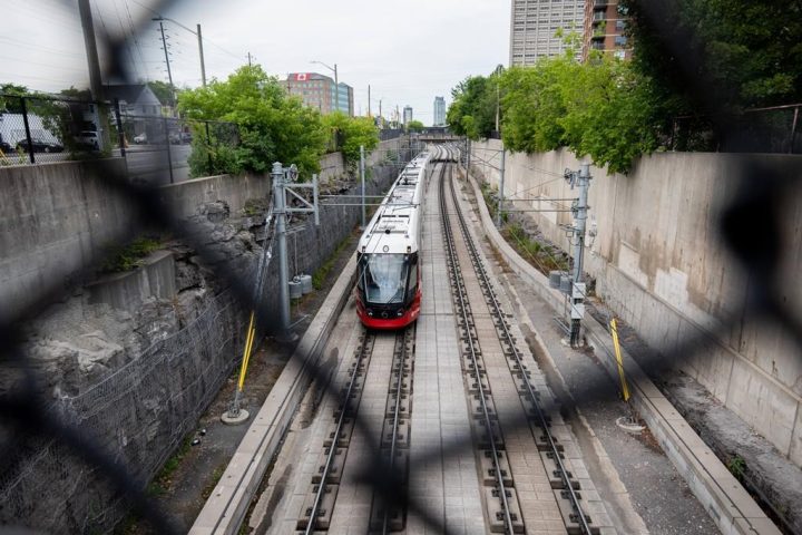 An Ottawa Light Rail Transit (LRT) train drives along the tracks in Ottawa, Ont. on Sunday, July 24, 2022. 
