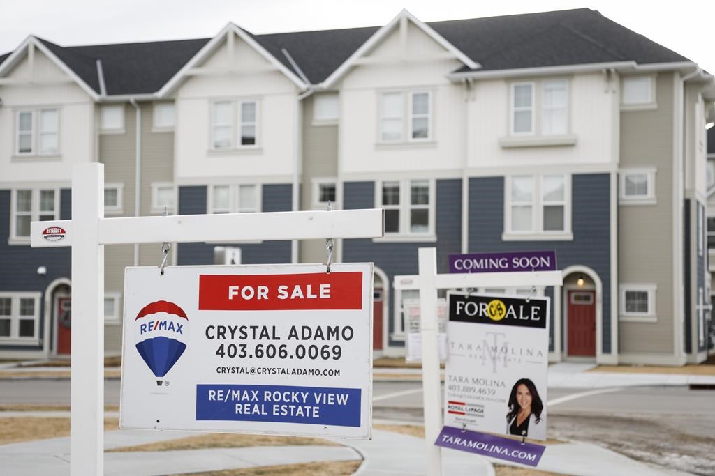Houses for sale are shown in a new subdivision in Airdrie, Alta., Friday, Jan. 28, 2022. The Calgary Real Estate Board says October home sales in the region fell by 15 per cent since last year but remained above pre-pandemic levels and were coupled with price increases. 