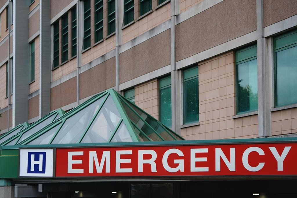 A hospital building 'Emergency' sign entrance.