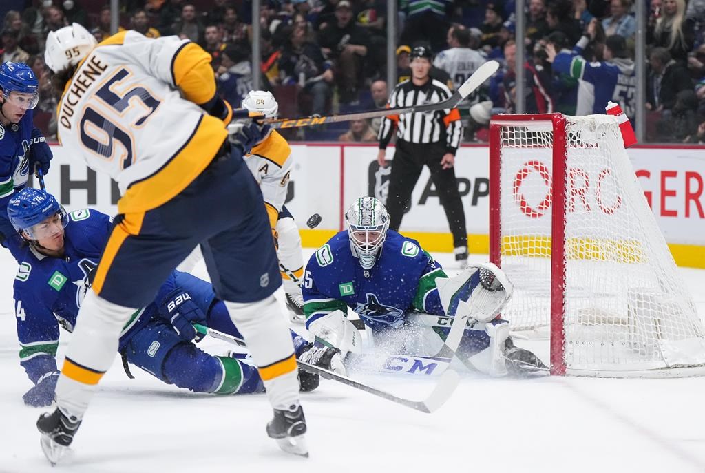 Nashville Predators' Matt Duchene (95) has his shot blocked by Vancouver Canucks' Ethan Bear (74) in front of goalie Thatcher Demko (35) during the first period of an NHL hockey game in Vancouver, on Saturday, November 5, 2022. THE CANADIAN PRESS/Darryl Dyck.