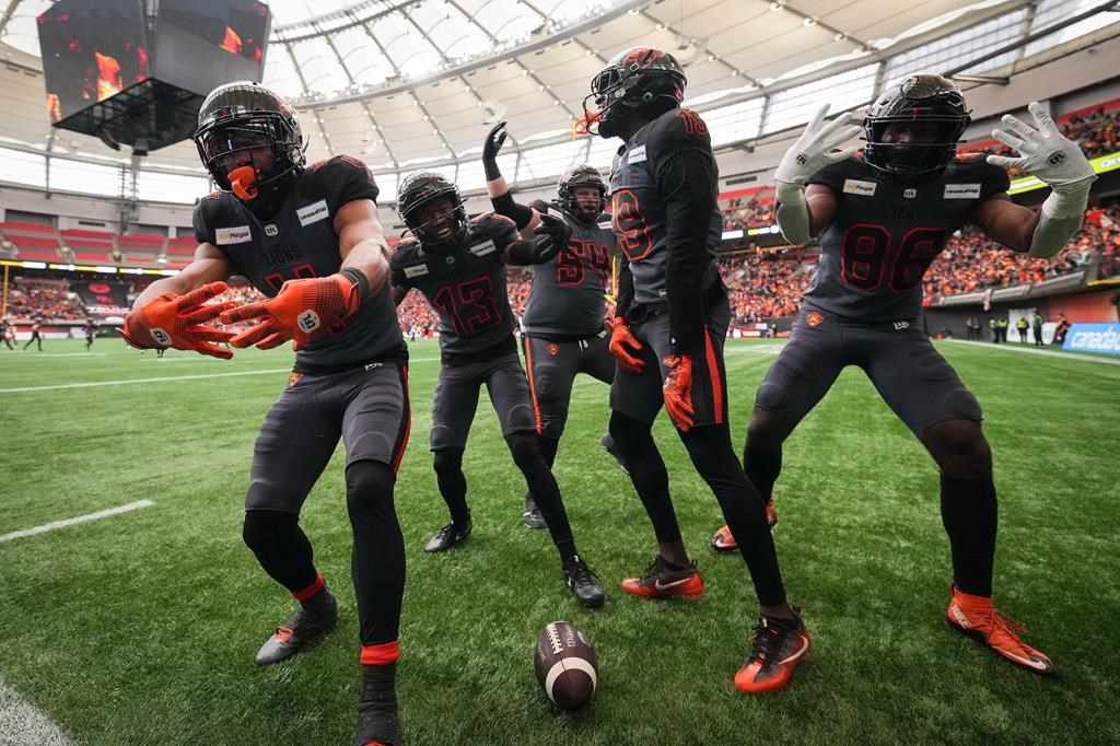 B.C. Lions' Keon Hatcher, from left to right, Alexander Hollins, Andrew Peirson, Dominique Rhymes and Jevon Cottoy celebrate Hatcher's touchdown against the Calgary Stampeders during the second half of the CFL western semifinal football game, in Vancouver, B.C., Sunday, Nov. 6, 2022. THE CANADIAN PRESS/Darryl Dyck.