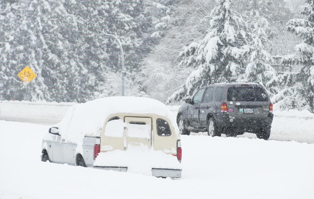 Vehicles make their way along the snow-covered highway in Victoria, B.C., Tues. Feb. 12, 2019.
