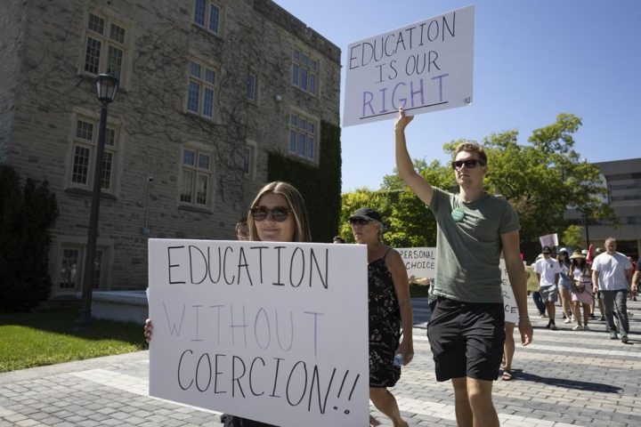 A group of Western University students hold a protest against the school's COVID-19 mandates on Saturday Aug. 27, 2022. The University of Waterloo is returning to required masking for indoor activities that are part of academic instruction. 