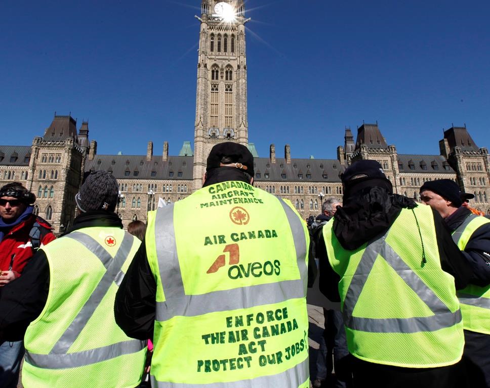 Locked-out Aveos maintenance workers, who maintained Air Canada aircraft, protest on Parliament Hill in Ottawa, Tuesday March 27, 201. Air Canada violated federal law by not keeping its aircraft maintenance centres in Montreal, Winnipeg and Mississauga operational during the collapse of Aveos, a decade ago, the Quebec Superior Court ruled Thursday in a ruling for thousands of former workers.