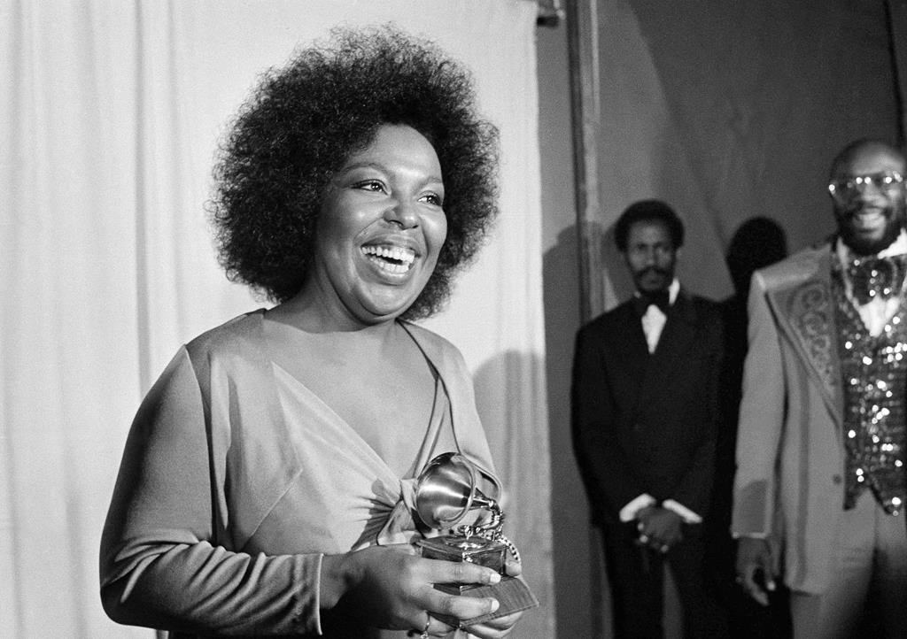 In this March 4, 1974 file photo, Roberta Flack holds the Grammy award for her record, "Killing Me Softly With His Song" as singer Isaac Hayes, right, looks on at the Grammy Awards in Los Angeles.