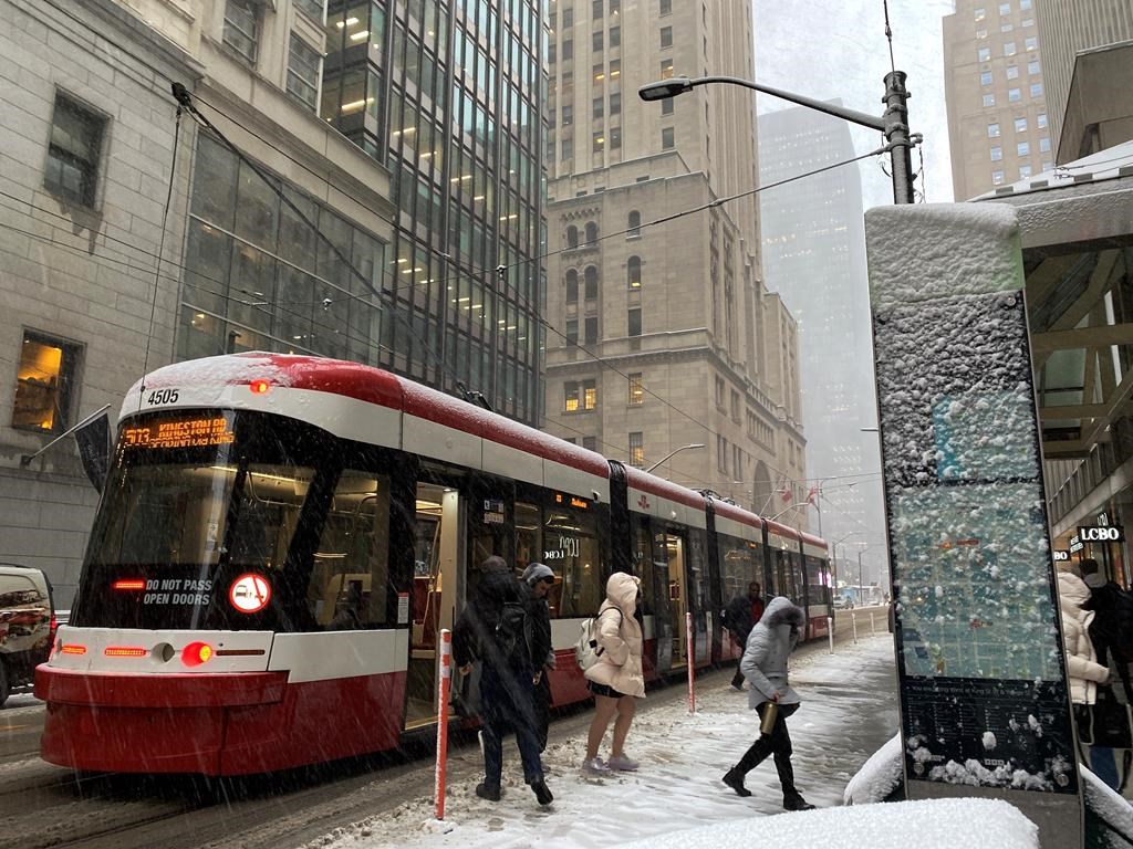 Passengers step off a streetcar during a snowy day in Toronto on Tuesday, Nov.15, 2022. THE CANADIAN PRESS/Graeme Roy.