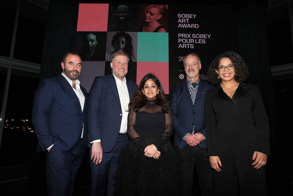 Divya Mehra, 2022 Sobey Art Award winner, is flanked by (from left to right) Bernard Doucet, Executive Director, The Sobey Art Foundation; Jonathan Shaughnessy, Director, Curatorial Initiatives, National Gallery of Canada, and Chair of the jury; Rob Sobey, Chair, The Sobey Art Foundation; and Angela Cassie, Interim Director and CEO, National Gallery of Canada.  