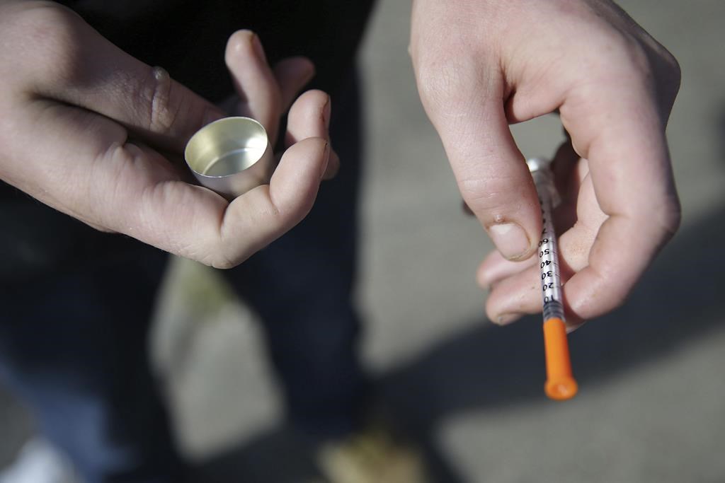 A fentanyl user holds a needle near Kensington and Cambria in Philadelphia, on Oct. 22, 2018. Toronto Public Health is issuing a drug alert after a spike in suspected fatal overdoses.THE CANADIAN PRESS/David Maialetti-The Philadelphia Inquirer via AP.