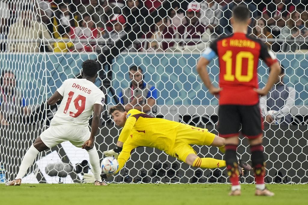 Belgium goalkeeper Thibaut Courtois (1) makes a save on a penalty kick from Canada forward Alphonso Davies (19) during first half Group F World Cup soccer action at Ahmad bin Ali Stadium in Al Rayyan, Qatar, on Wednesday, Nov. 23, 2022.
