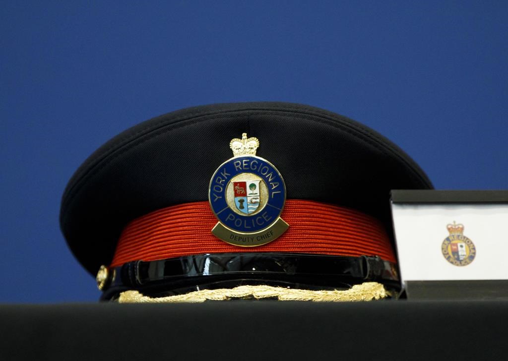 A York Regional Police deputy chief's hat is seen on a table during a press conference at the YRP Headquarters in Aurora, Ont., Monday, March 11, 2019. Ontario's police watchdog says one man is dead and another was rushed to hospital after they were shot by officers northeast of Toronto. 
