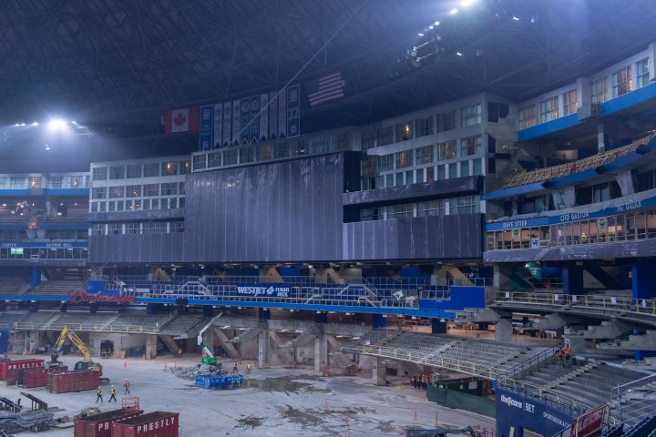 Construction work is underway near the video screen.