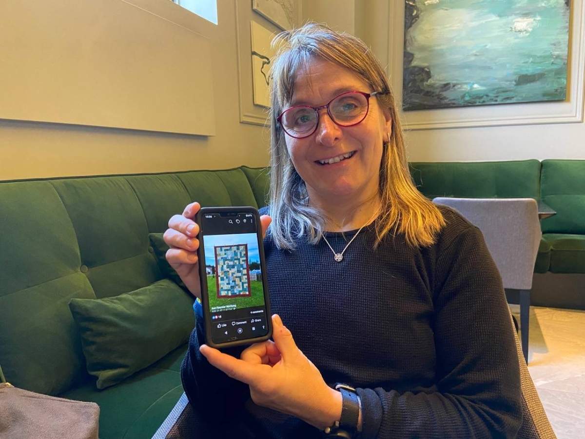 Canadian army veteran Ann Fournier McClung with quilt used for fundraising for Ukraine.