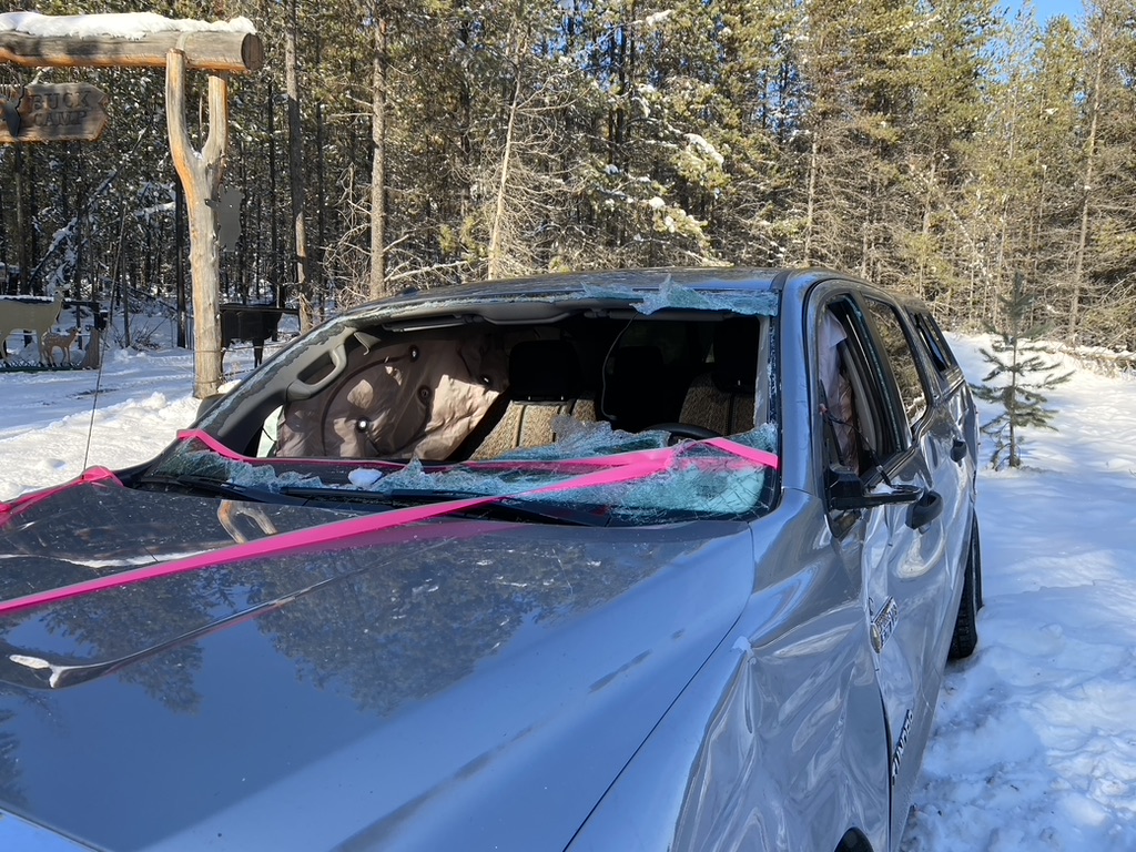 A photo showing the damaged truck, and how rescue crews had to chop open the windshield while it was overturned to free the two trapped occupants.