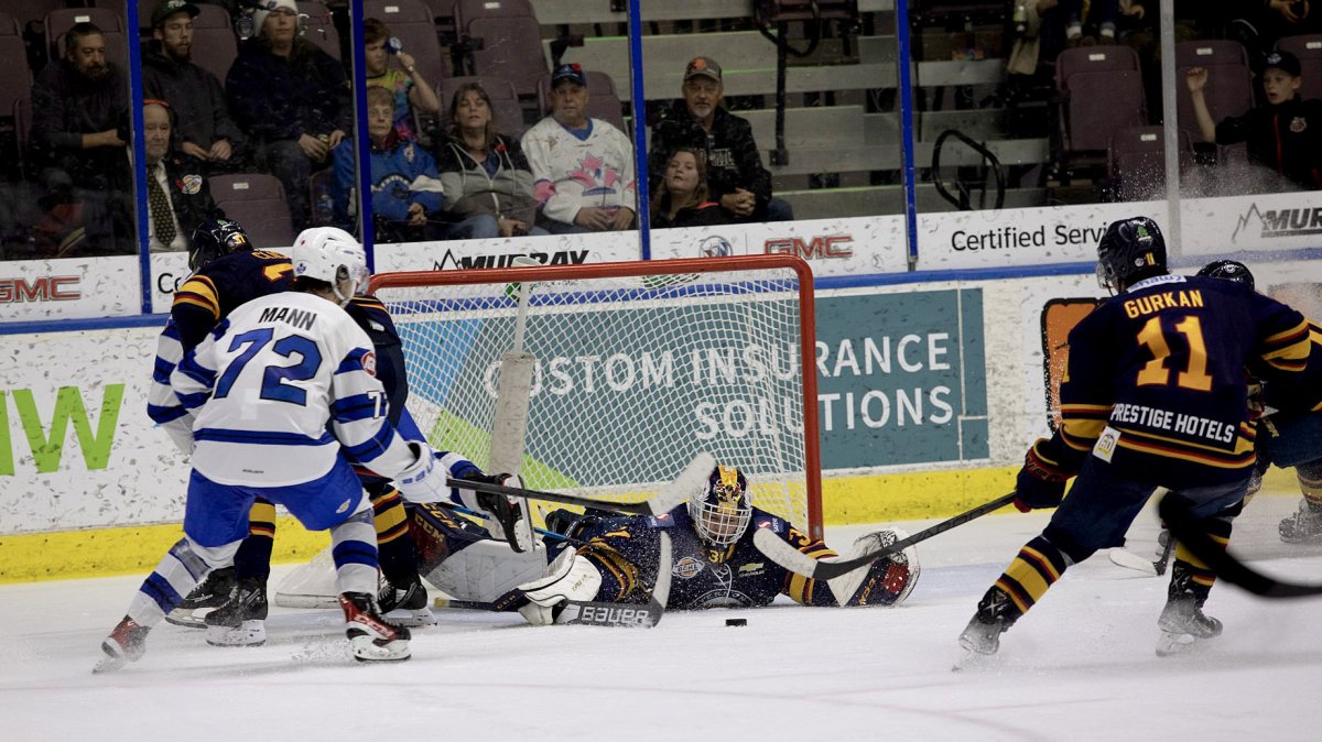 Vernon Vipers goaltender Roan Clarke, middle, scrambles for the puck during BCHL action against the Penticton Vees in Penticton on Friday, Nov. 11, 2022.