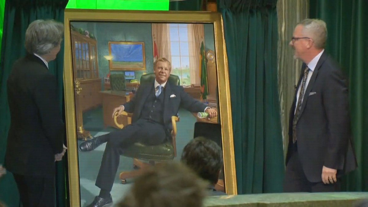Former Saskatchewan premier Brad Wall (right) can be seen looking at his portrait on Nov. 30, 2022.