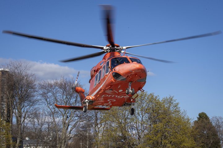An Ornge air ambulance C-GYNH takes-off from the helipad outside the Kingston general hospital in Kingston, Ontario on Sunday April 25, 2021. A passenger on a snowmobile was airlifted to hospital after a crash west of Ottawa.