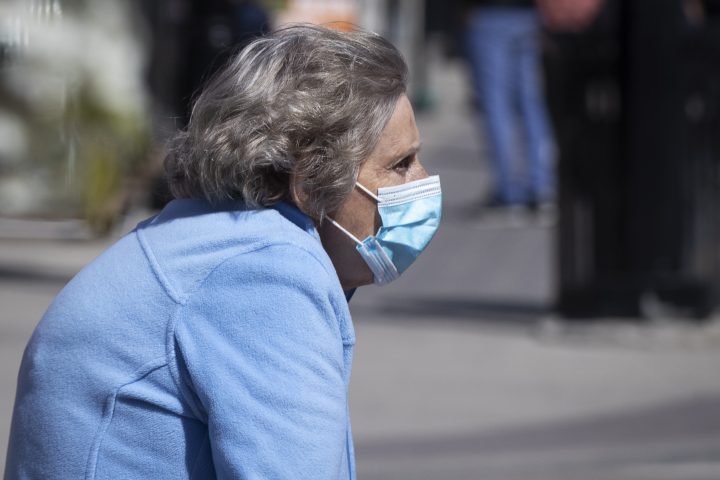 A senior person wears a surgical mask to protect them from the COVID-19 virus in Kingston, Ontario on Monday May 10, 2021. 