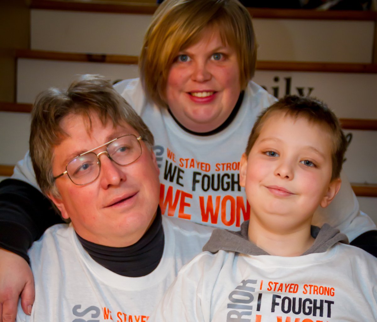 Lesley McGill wraps her arms around her husband Randy and her son William on the day they celebrated the end of William’s chemo treatments in Halifax as shown in this handout image from 2016.